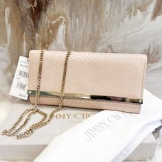 This Jimmy Choo Clutch Bag Is A Stunning Addition To Any Outfit. The Exterior Is Made Of High-Quality Leather In A Beautiful Pink Snakeskin Pattern. The Chain Strap Adds A Touch Of Elegance And Can Be Worn Over The Shoulder Or As A Clutch. Stunning Authentic Jimmy Choo Milla Clutch Light Pink Iridescent Snakeskin Leather With Thick Gold Chain Accent. Snap Front Closure Comes With Dustbag Excellent Condition - Comes With Duster And Tag Attached. Some Scratches Lightly If You Zoom Just From Storin Luxury Pink Leather Clutch, Pink Clutch For Formal Occasions, Elegant Blush Bag For Formal Occasions, Luxury Blush Formal Bags, Elegant Blush Bags For Formal Occasions, Elegant Formal Blush Bags, Pink Clutch With Chain Strap For Formal Occasions, Designer Blush Bags For Formal Occasions, Formal Pink Clutch With Chain Strap