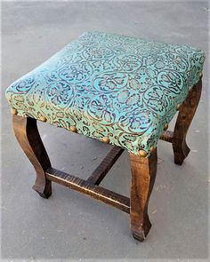 an upholstered bench sitting on the ground