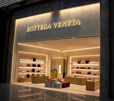 the entrance to bottega veneta is lit up with lights and shoes