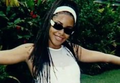 a woman with long hair wearing sunglasses and a headband