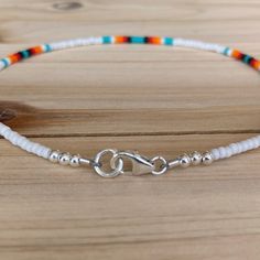 The Sunrise Dainty anklet is the same beautiful design as the original but with smaller beads that still make a statement! This ombre of colors is just what you need for a fun day in the sun. All anklets are customizable to the size you need so please be sure to measure your ankle where you want your anklet to sit and order accordingly! This high quality beaded anklet is finished with sterling silver accents, secured with a sterling silver lobster claw and made with glass beads that can stand th Handmade White Anklet Bracelet, Adjustable White Anklets With Colorful Beads, Festival Anklets With Beaded Round Beads Chain, Festival Anklets With Beaded Chain, White Beaded Chain Anklets As Gift, White Bohemian Beaded Bracelets With Lobster Clasp, White Beaded Chain Anklets For Gift, White Beaded Anklets For Festival, White Beaded Festival Anklets