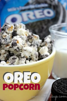 oreo popcorn in a yellow bowl next to an oreo cookie and glass of milk