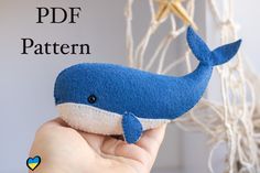 a blue whale stuffed animal being held by someone's hand with the caption pdf pattern