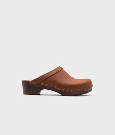 low heeled clog mules in dexter tan nubuck leather stapled on a dark wooden base with brass gold studs Sandgrens Clogs, Clog Mules, Studded Clogs, Heeled Mule, Cork Sandals, Wooden Clogs, Clog Sandals, Nubuck Leather, Mens Sandals