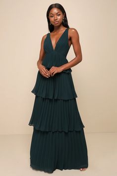 The ambiance of any room will be instantly more elegant when you walk in wearing the Lulus Mesmerizing Essence Emerald Pleated Backless Tiered Maxi Dress! Airy pleated woven chiffon shapes a sleeveless bodice with a flirty V-neckline and slender tying straps that secure above an even flirtier open back, all supported by wide shoulder straps. The flattering, empire-style waist tops a sweeping maxi skirt adorned with flouncy tiers throughout the A-line silhouette. Hidden back zipper/clasp. Emerald Bridesmaid Dresses, Backless Gown, Pleated Gown, Dark Green Dress, Bridal Party Dresses, Pleated Maxi Dress, Maxi Dress Green, Tiered Maxi Dress, Lulu Dresses