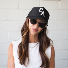 Our trucker style hat is the perfect accessory for errands, a playdate, the big soccer game or basically any occasion at all. *ALL HATS ARE FINAL SALE* 100% POLYESTER - One size fits most - Foam front, mesh back and terry sweatband - Black Otto 39-165 hat - Custom white puff lettering "CA" - Adjustable snap back Care Instructions: Spot clean only. Can be gently steamed if bent or creased. Sporty Everyday Snapback Baseball Cap, Trendy Sports Snapback Hat With Flat Brim, Trendy Flat Brim Snapback Hat For Sports, Sporty Flat Brim Baseball Cap For Everyday, Everyday Curved Brim Snapback Hat For Baseball Season, Trendy Snapback Baseball Cap For Sports Events, Trendy Snapback Baseball Cap For Sports, Sporty Hats For Baseball Season, Sporty Everyday Hats For Baseball Season