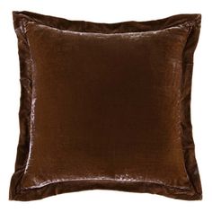 a brown velvet pillow on a white background