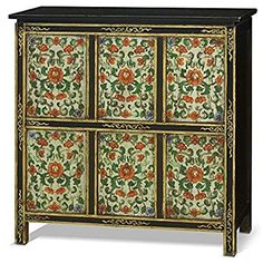 an ornately decorated cabinet with flowers and leaves painted on it's sideboard