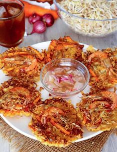 there is a plate with shrimp on it and the words vegetable and shrimp fritters