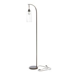 a floor lamp with a glass shade on the top and a cord attached to it