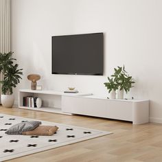 a flat screen tv mounted on the wall above a white entertainment center in a living room