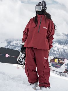 a snowboarder is standing in the snow with his board