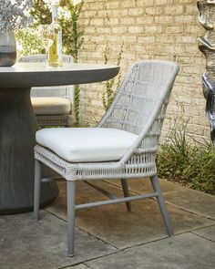 a white wicker chair sitting next to a table