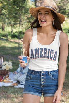 Gear up for summer holidays with our retro style America unisex tank -- great for men or women! Graphic is distressed for that instant vintage vibe. Looking for more 4th of July gear? Check these out: https://www.etsy.com/shop/TheGraphicPeach?ref=seller-platform-mcnav§ion_id=33390667 Our shop uses direct-to-garment printing to make our products. The design ink is sprayed on, then allowed to soak into the fibers of the garment. This process yields fine quality prints and a smooth finish on the ga Summer Tank Top With Text Print, Summer Sleeveless Tank Top With Text Print, Sleeveless Tank Top With Text Print For Summer, 4th Of July Cotton Tank Top With Letter Print, Casual Summer Tank Top With Text Print, Casual 4th Of July Tank Top With Letter Print, Summer American Flag Print Tank Top, American Flag Print Cotton Tank Top For Summer, Patriotic Cotton Tank Top For Spring