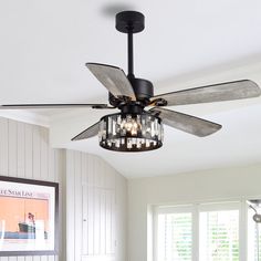 a ceiling fan with lights hanging from it's blades in a living room area