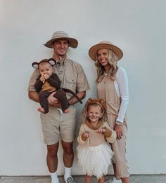 a man, woman and child are dressed up in animal costumes while standing next to each other