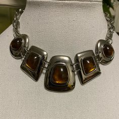 This Is A Sexy Piece Of Neck Art. Tiger Eye Type Stones Laid Silver Frames Is A Fantastic Combination. Each Frame Containing A Stone Connected With (2) Silver Rings. Each End Of The (5) Frames Are Also Connected With (2) Rings To The Chain Link Necklace Which Adds That Pop To This Piece. Has A Lobster Clasp With Extender. **Comes With Free Earrings** Pic Included. Silver Metal Necklaces For Night Out, Silver Metal Necklace For Night Out, Party Metallic Necklaces, Unique Brown Nickel-free Jewelry, Brown Nickel-free Metal Necklace, Brown Multi-strand Costume Jewelry, Nickel-free Brass Necklace In Brown, Unique Brown Multi-strand Necklace, Black Agate Stone