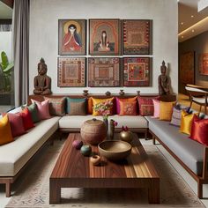 a living room filled with lots of furniture and paintings on the wall above it's coffee table