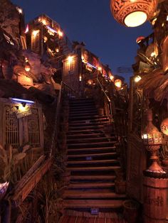 a set of stairs leading up to a building with lots of lights on top of it