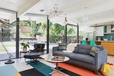 a living room filled with furniture and lots of windows