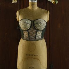 Absolutely gorgeous beige and forest green backless bustier, corset style bra! Label reads 'Backless' by Young Smoothie by The Strouse Adler Co, 36 D, Cups and Panels - 100% nylon, Elastic - nylon spandex. Size 36D Fits a women's modern size MEDIUM / LARGE cup size D Intricate classic lace on the bodice with a low back "backless" silhouette. Features underwire cups that are sheer and non-padded.  Boning throughout (6 bones). Strapless 3 hook-and-eye closures with 2 size options. Lovely beige floral lace front. Rich, forest green stretch side panels. Comfortable stretch wide elastic waist becoming 'backless' in the back. Hand dyed. Shown on a size L dress form with a 38.75" bust, 30.5" waist, 39.75 hips. Best for a woman's MEDIUM 36 D. Condition:  ready to wear! The elastic is stretchy and Style Corset, Corset Boning, Bra Items, Lace Underwire, Corset Style, Dress Form, Cup Size, Side Panels, Bra Lingerie