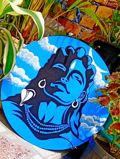 a blue frisbee sitting on top of a table next to potted plants