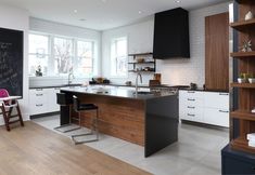 a large kitchen with an island in the middle and lots of counter space next to it