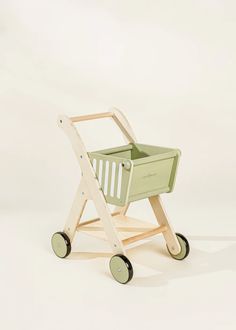 a wooden toy wagon with wheels and a basket on the top, sitting against a white background