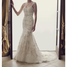 a woman standing in front of a doorway wearing a wedding dress