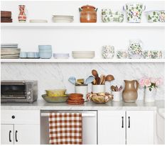 the kitchen counter is full of dishes and utensils