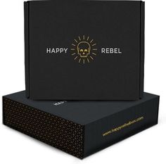 a black box with a skull on it and the words happy reebl written in gold