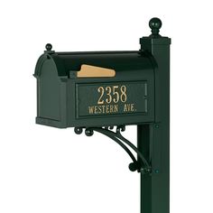 a green mailbox with a brown paper sticking out of it