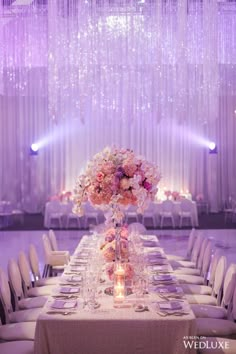 a table set up for a wedding with flowers and candles