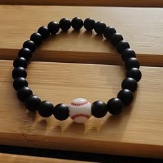 A Bracelet For The Baseball Fan. Black Matte Onyx Beads Baseball Bracelet 8 Inch. Unisex Hand Model Has A 6 Inch Wrist. 8mm Black Beads. Father's Day, Brother, Sister, Father, Husband, Sports Fan. Baseball Mom Bracelet Stack, Personalized Black Beaded Bracelets For Father's Day, Baseball Bracelet Diy, Father’s Day Beaded Bracelet, Baseball Bracelets For Men, Baseball Mom Bracelet, Baseball Bracelet, Bracelets Black, Moms Bracelet