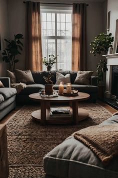 a living room with two couches and a coffee table in front of a window