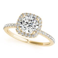 a yellow gold engagement ring with an oval halo setting and pave set diamonds around the band