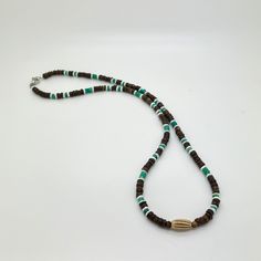 This handcrafted tribal necklace features brown coconut heishi beads, REAL green Turquoise, white Shell and Carved horn focal center bead with choice of silver or 18K Gold-plated stainless steel clasp. Note: focal center bead is randomly selected from bone, horn or sandcast clay; therefore, no two will be identical. Turquoise is the stone of truth, grounding, protection, and calmness. It enhances communication, amplifies intuition, and brings insight and wisdom. Turquoise effectively dispels neg Handmade Brown Heishi Bead Necklace, Brown Polished Beads For Beach, Brown Heishi Beads Round Necklaces, Handmade Brown Heishi Beads, Brown Heishi Beads Necklace For Gift, Brown Heishi Beads Necklace Gift, Radio Waves, Real Green, Heishi Necklace