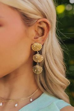 Go for a stylish beachy vibe with these chic earrings! - Gold colored material with faux pearl accents - A seashell stud with dangling seashells design - Post and backs - Length: 2.6 inches Beach Earrings, Chic Earrings, Fairytale Dress, Jean Accessories, Shell Earrings, Lace Fashion, Earrings Gold, Sock Shoes, Earring Necklace