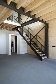 an empty room with stairs leading up to the second floor