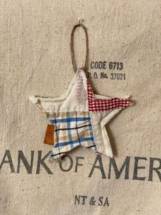 an ornament hanging from the side of a bag with a checkered star on it