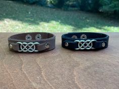 Black or Brown leather bracelet with a silver double infinity . The band is 5/8" wide with a two position snap closure & will fit a wrist that measures 6-1/2" - 7-1/2". Please check measurements for a comfortable fit. Can be made in different size if requested. ' Adjustable Silver Double Band Leather Bracelet, Adjustable Double Band Silver Leather Bracelet, Silver Adjustable Double Band Leather Bracelet, Silver Double Band Adjustable Leather Bracelet, Double Infinity, Brown Leather Bracelet, Knoxville Tn, Snap Closure, Halloween Shopping