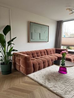 a living room filled with furniture and a large window