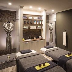 two spa beds with towels on them in a room