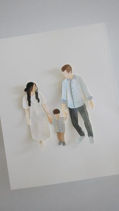 a paper cutout of a family is hanging on the wall