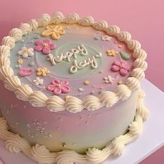 a birthday cake with frosting and flowers on it