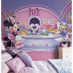 a child's bedroom decorated in pink and purple with minnie mouse wall decals