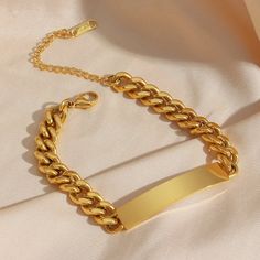 This statement chain bracelet is a fun stackable piece you'll never want to take off. A gold Cuban link chain features a glossy golden plate for added sparkle and shine. DETAILS & SIZE Finish: 18k gold plate Materials: 316L Stainless Steel Measurements: Circumference: 6" + 2" extension; Chain width: 3mm, 6mm, 8mm Waterproof, tarnish-resistant, and nickel free Shop Bracelets for more options to layer this with! Bracelet Stands, 18k Gold Bangle, Gold Cuban Link Chain, 18k Gold Chain, Gold Chain Jewelry, Gold Bracelet Chain, Cuban Link Chain, Cuban Chain, Cuban Link