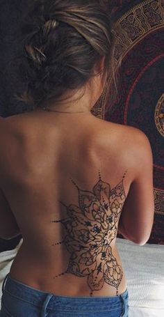 a woman with a tattoo on her back