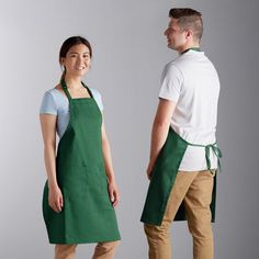 a man and woman in aprons standing next to each other