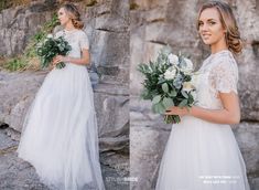 a woman in a white wedding dress holding flowers next to a stone wall with greenery